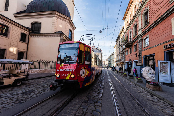 LVIV, UKRAINE - OCTOBER 23, 2019: red tram with favbet lettering on street in city center - Valokuva, kuva
