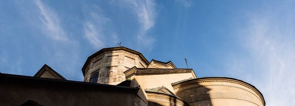 horizontal image of ancient church against blue sky in lviv, ukraine - Photo, Image
