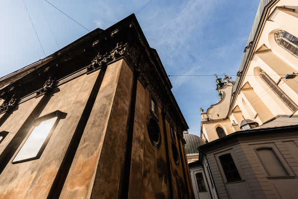 low angle view of medieval buildings against blue sky in lviv, ukraine - Foto, immagini