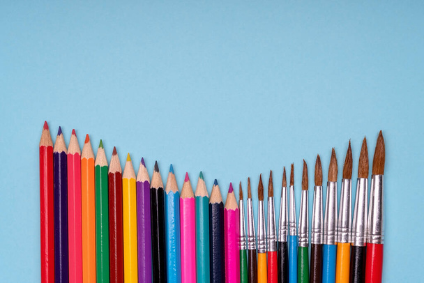 Paint brushes with colorful pencils. School and preschool education. Art and painting. Conceptual and creative photography. Copy space. - 写真・画像