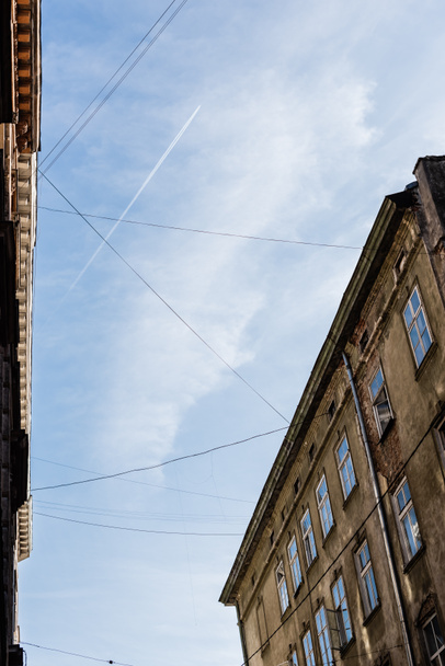low angle view of old houses and electrical wires against blue sky in lviv, ukraine - Photo, Image