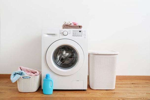 Washing machine, washing gel and laundry baskets on white background - Zdjęcie, obraz