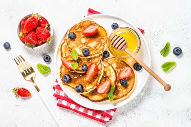 Pancakes with fresh berries and honey. - Photo, Image