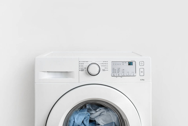 Working washing machine on white background - Foto, Imagen