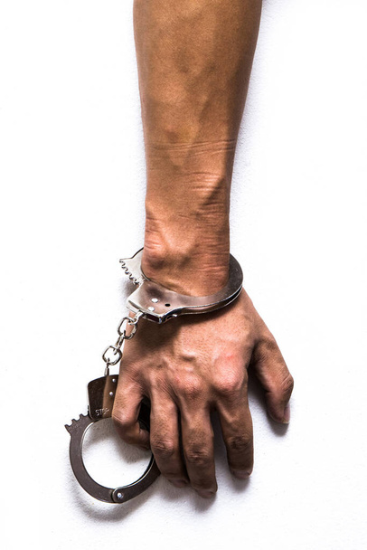 Arm on white background with handcuff locked - Photo, Image