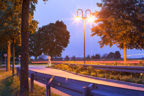 Νυχτερινά φώτα στο δρόμο Dachauer στην πόλη Emmering. - Φωτογραφία, εικόνα