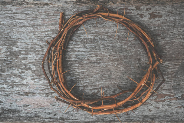 Thorn crown made from real branches with spikes on wooden background - 写真・画像