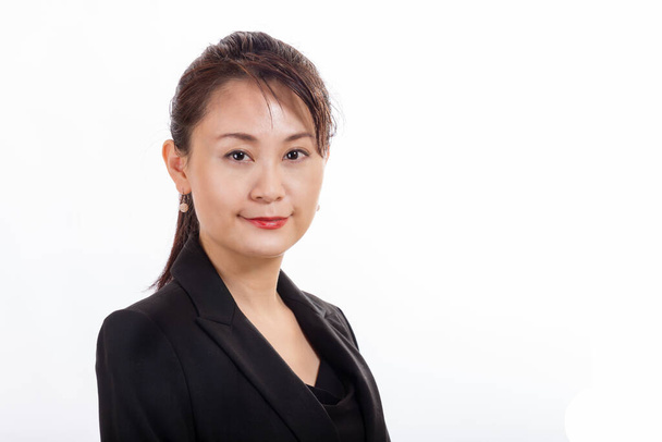 Asian American businesswoman looking at camera on white background - Fotó, kép