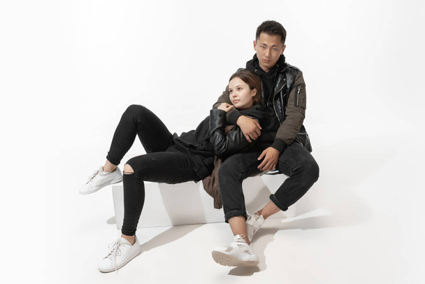 Trendy fashionable couple isolated on white studio background - Foto, Imagen
