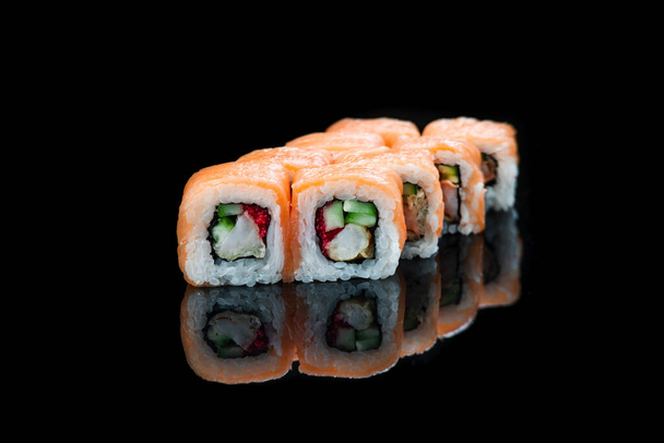 Sushi Roll On A Black Background reflection . Japanese food. Close Up. - Foto, afbeelding