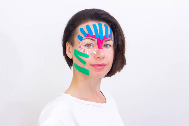 Face taping, close-up of a girls face with cosmetological anti-wrinkle tape. Face aesthetic taping. Non-invasive anti-aging lifting method for reduction of wrinkles - Foto, immagini