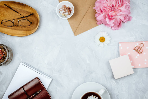 Feminine business mockup with stationery supplies, daisies, peony flowers, notebooks and glasses, flatlay on cement background - Photo, Image