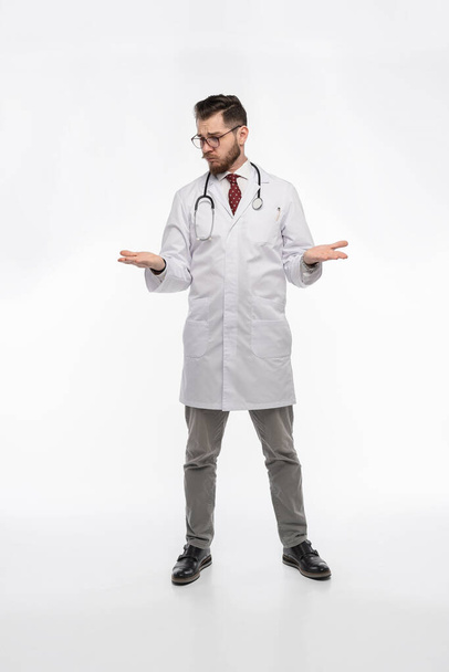 A portrait of a medical doctor posing against white background - 写真・画像