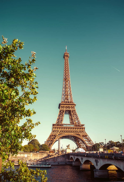 The Eiffel Tower in Paris against the backdrop of the Seine River. Retro processing - Photo, Image