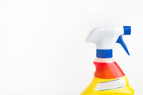 A close-up of the top portion of a red, white, and blue liquid spray plastic dispenser bottle set on a plain white background. - Photo, image