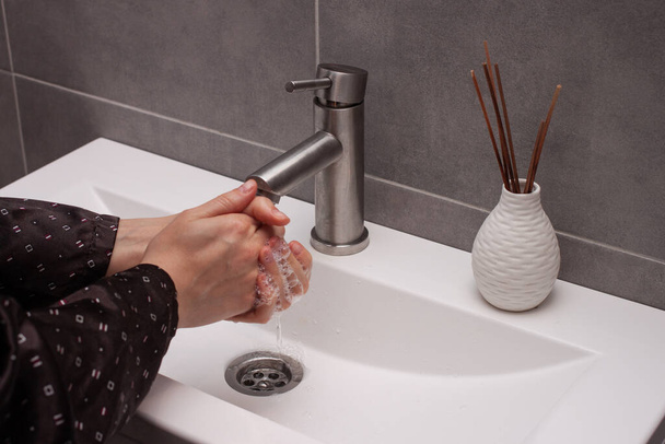 Πλένει τα χέρια τρίβοντας με τον άνθρωπο σαπούνι για την πρόληψη του ιού του στέμματος, υγιεινή για να σταματήσει την εξάπλωση του ιού του στέμματος.M - Φωτογραφία, εικόνα