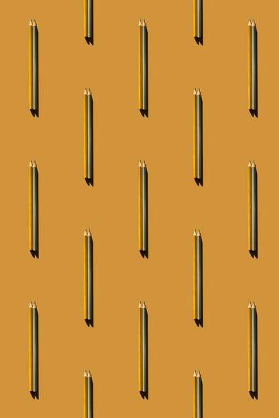Pattern of gold and silver pencils on gold background. - Fotografie, Obrázek