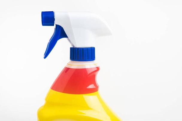 A close-up of the top portion of a red, white, and blue liquid spray plastic dispenser bottle set on a plain white background. - Valokuva, kuva