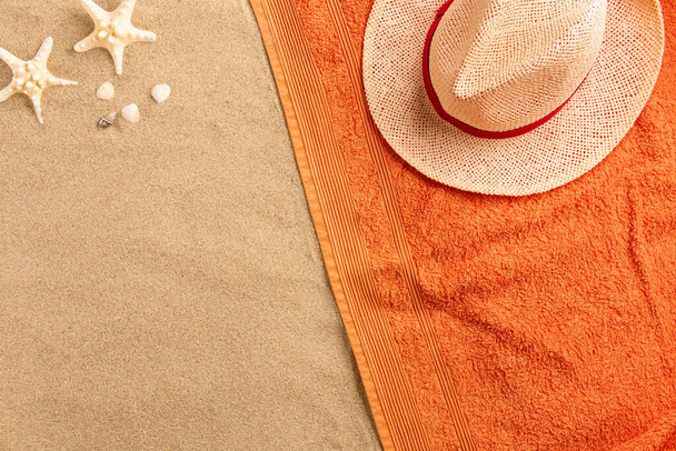 Top view of sandy beach with summer accessories. Background with copy space and visible sand texture.  - Valokuva, kuva