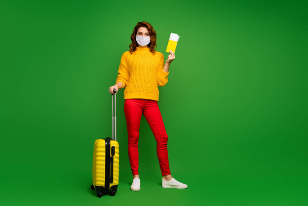 Full length body size view of her she nice attractive wavy-haired girl wearing mask departing abroad resort hotel rest relax safe measures isolated bright vivid shine vibrant green color background - Photo, image