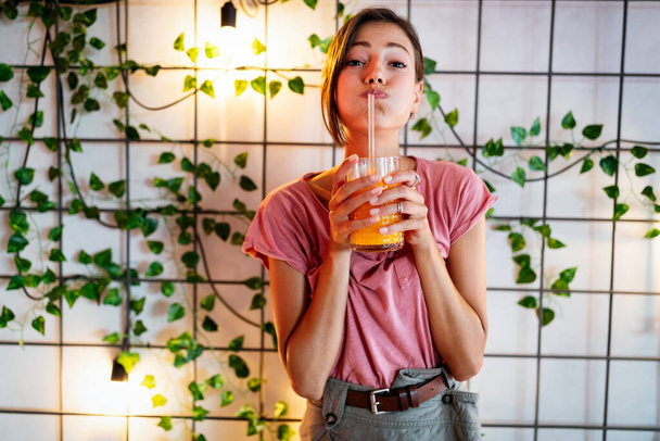 Portrait of beautiful woman holding glass with healthy tasty juice - Foto, Imagem