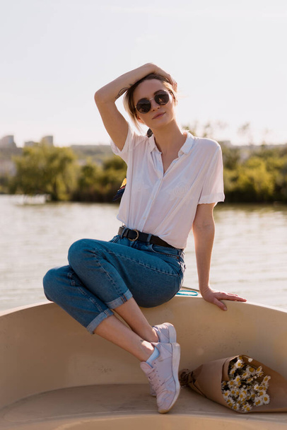 Fashionable woman in sunglasses on the boat - 写真・画像