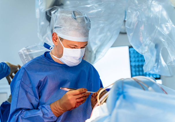 Surgeon at work in operating room. Modern equipment in operating room. Medical devices for neurosurgery. - Foto, immagini