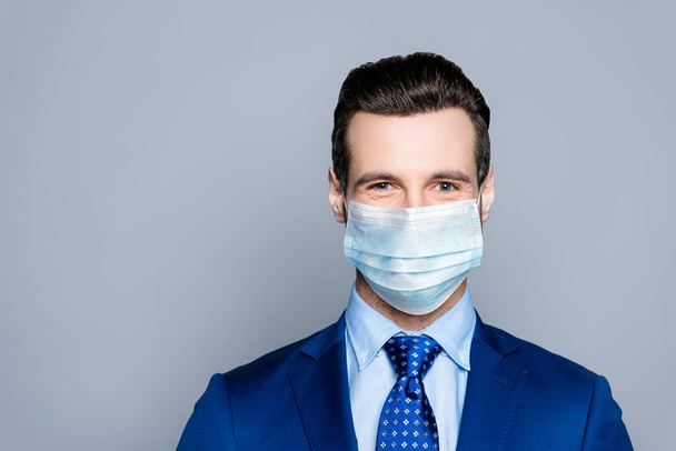 Close-up portrait of his he nice attractive imposing chic classy cheery guy corporate partner wearing medical gauze mask sars-ncov-s prevention isolated over grey pastel color background - Fotó, kép