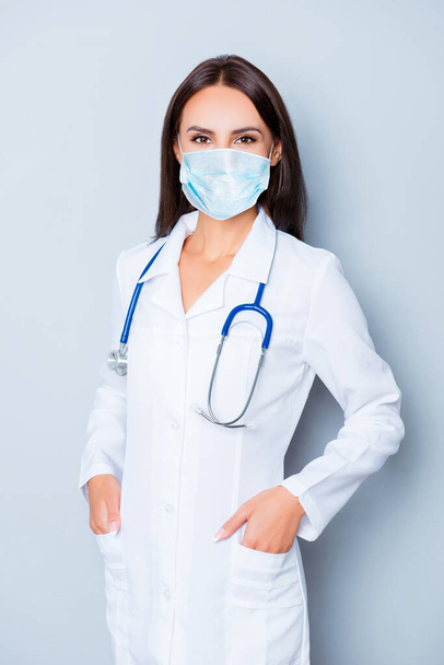 Portrait of pretty female doctor crossed hands wear medical safety sterile mask on face, pandemic corona virus prevention protection concept 2020 covid19 - Photo, image