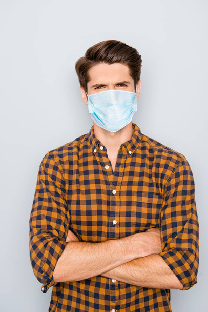 Portrait of young confident serious man with crossed hands wear medical safety mask on face, stop pandemic corona virus prevention protection concept 2020 covid19 - Фото, изображение