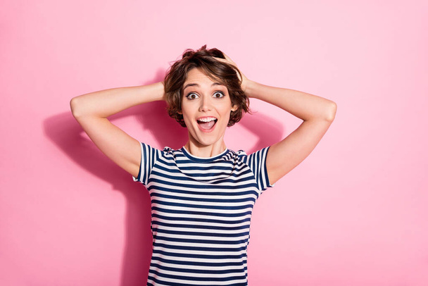 Photo of funky crazy lady short hairdo funny facial expression open mouth arms touch head yelling cool good news wear casual white blue t-shirt isolated pastel pink color background - Фото, зображення
