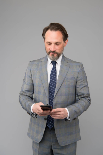 mature businessman answer email. professional business man in formal suit. confident male use mobile phone. trying to help someone. ceo in office jacket typing sms on smartphone - Фото, зображення