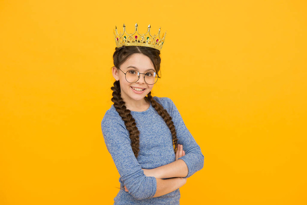 Being her own boss. Little boss yellow background. Happy child wear crown. Beauty queen. Prom party. Big boss concept. Glory and triumph. Luxury fashion accessories. That boss is truly amazing - Фото, зображення
