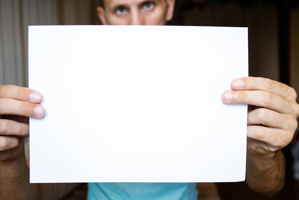 el tipo sostiene una sábana blanca en las manos extendidas, espacio de copia
 - Foto, Imagen