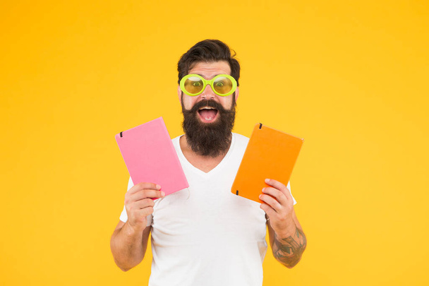 Interesting learning. Learning is fun. Studying with pleasure. Have fun. Learning with happiness. Funny cheerful adult man in sunglasses hold books. Study in college. Positive and energetic - Photo, Image