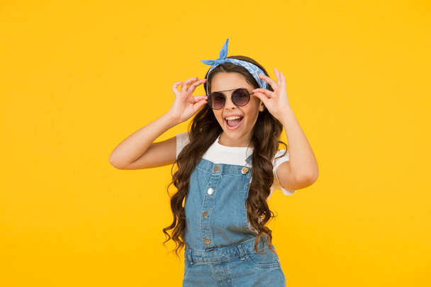 Enjoying new great day. happy childrens day. cheerful vintage girl on yellow background. little beauty at hairdresser. love her retro fashion style. summer vacation. summer shopping sales. pin up kid - Zdjęcie, obraz
