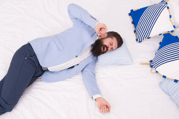 Business never sleeps. Bearded man yawn in business suit. Hipster lying in bed. Business elegant attire. Formalwear and business wear. Fashion and style. Menswear shop - Foto, immagini