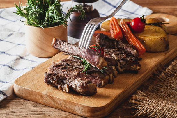 Steak on a wooden chopping board, ready to serve - Photo, Image