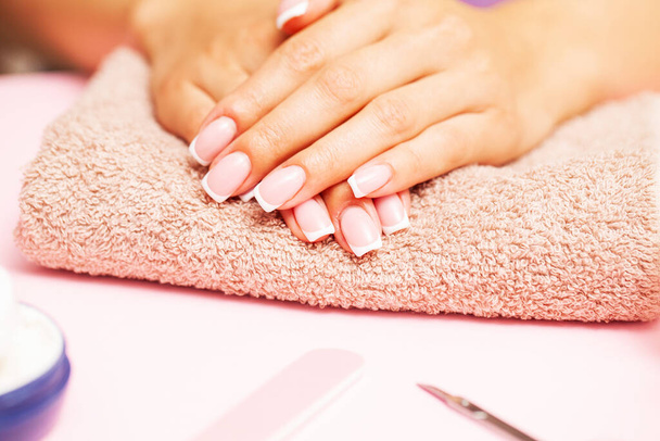 Beautiful woman hands with fresh french manicure - Photo, Image