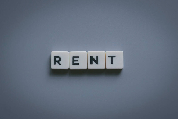 Rent word made of square letter word on gray background. - Valokuva, kuva