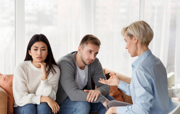 Советник разговаривает с несчастными супругами во время сеанса терапии в офисе
 - Фото, изображение