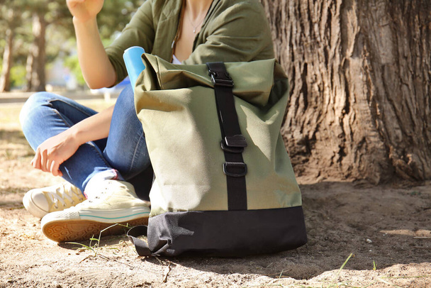 Female traveler with backpack in park - Фото, зображення