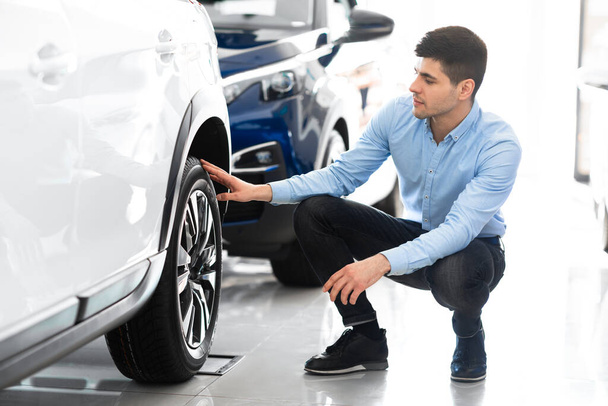 Man checking car wheel rims and tire - Foto, afbeelding