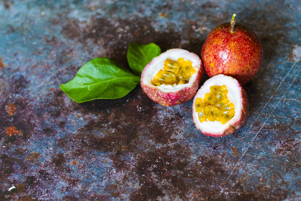 Fresh Tropical Passion Fruits on dark grunge background with copy space for background or wallpaper. Ripe passion fruit so sweet and sour. Tropical fruit. - Photo, Image