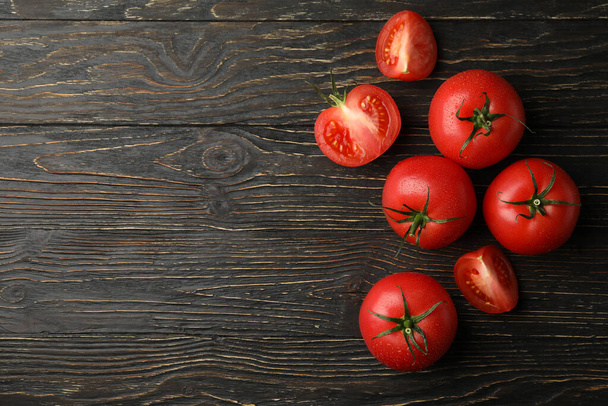 Fresh ripe tomatoes on wooden background, top view - Fotó, kép