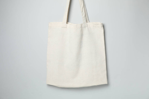 Empty white canvas bags on gray background, space for text. - Fotó, kép
