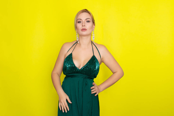 Fashion picture of beautiful young blonde woman wearing green evening dress. Elegant woman ready fo evening - Φωτογραφία, εικόνα