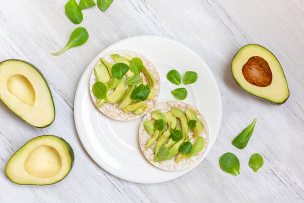Crispy rice cakes with sliced avocado. Healthy and fresh breakfast. Healthy and vegan concept  - Photo, Image