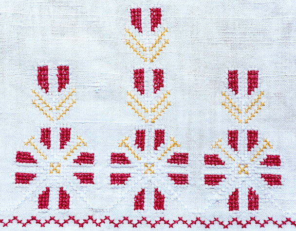 Fragment of embroidery handmade cross-stitch pattern on vintage tablecloth or napkin, ukrainian ethnic ornament - Photo, Image