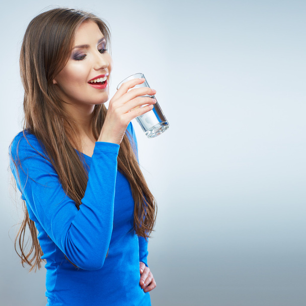 Casual style young woman holding glass with water . - 写真・画像